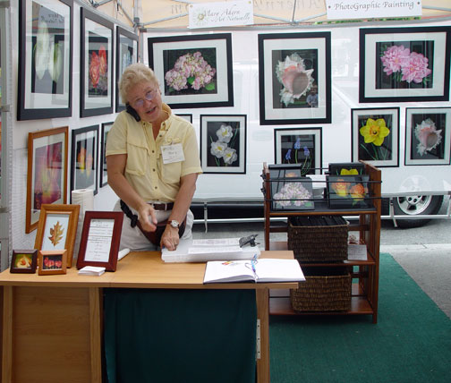 2007-05-28 Mary on cell phone answering questions at the Washington Square Outdoor Art Show, NYC