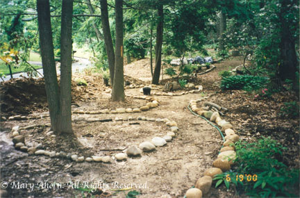 First hose and then rocks help to define the woodland walkways